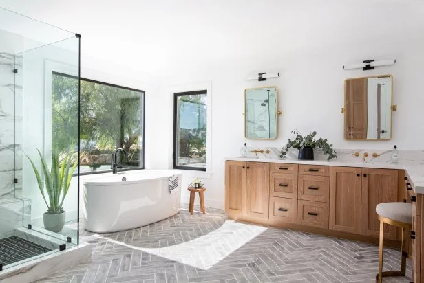 Bright bathroom with freestanding tub and wood vanity